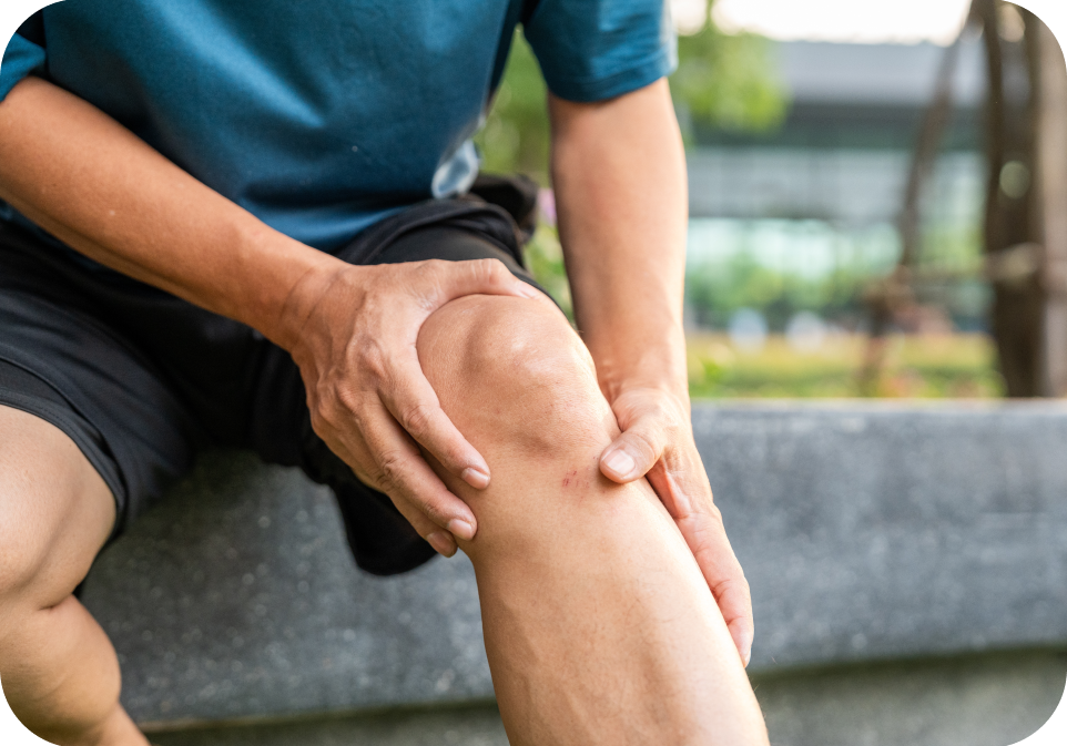 Person holding knee outdoors, highlighting bone health and mineral supplement support.