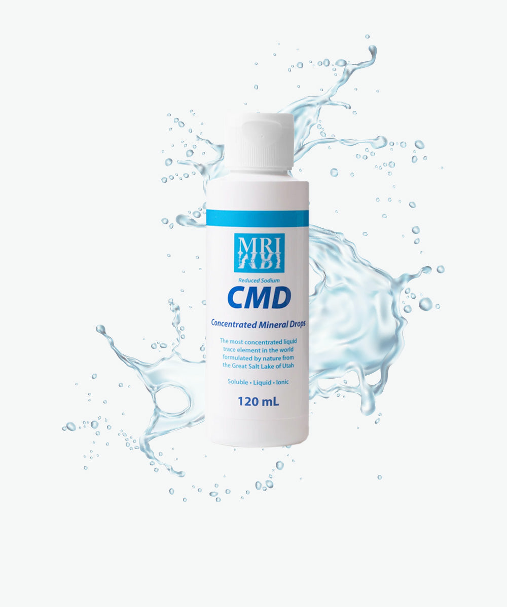 CMD Concentrated Mineral Drops 120ml bottle with splashing water background, electrolyte supplement