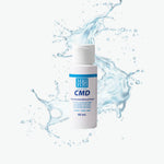 CMD bottle with water splash on a white background