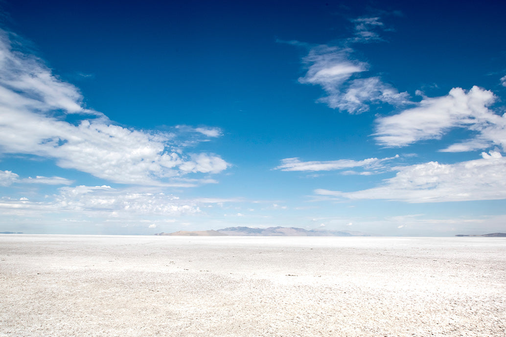 Desert landscape with a clear blue sky and scattered clouds
